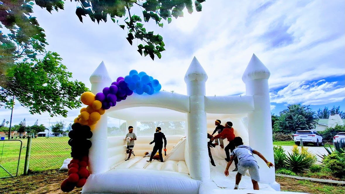 Kids jumping in the bounce castle at a birthday party